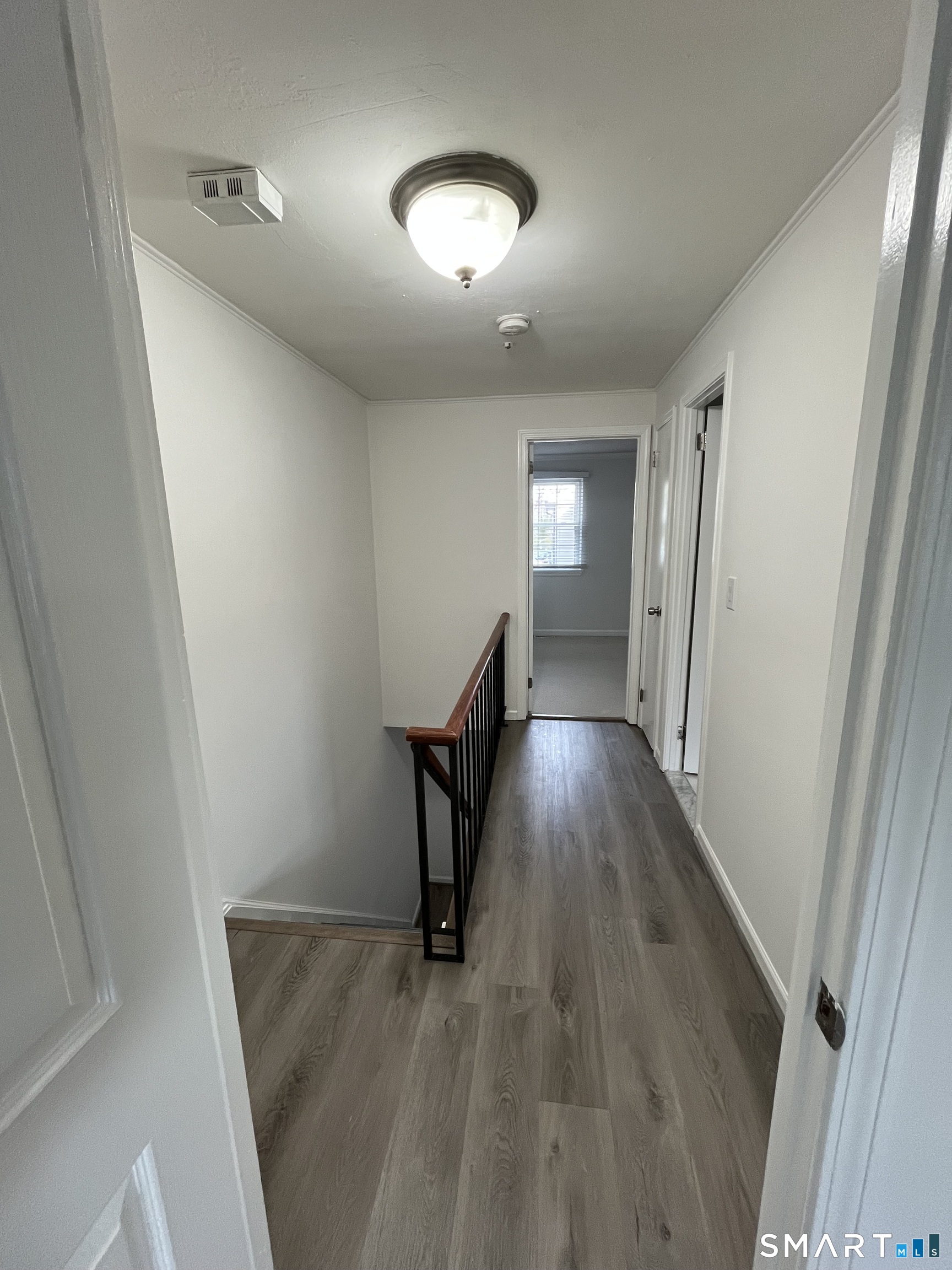 88 East Gate Lane, Unit 88 Hamden, CT 06514 - Photo 21 of 62 a view of a hallway with wooden floor and staircase