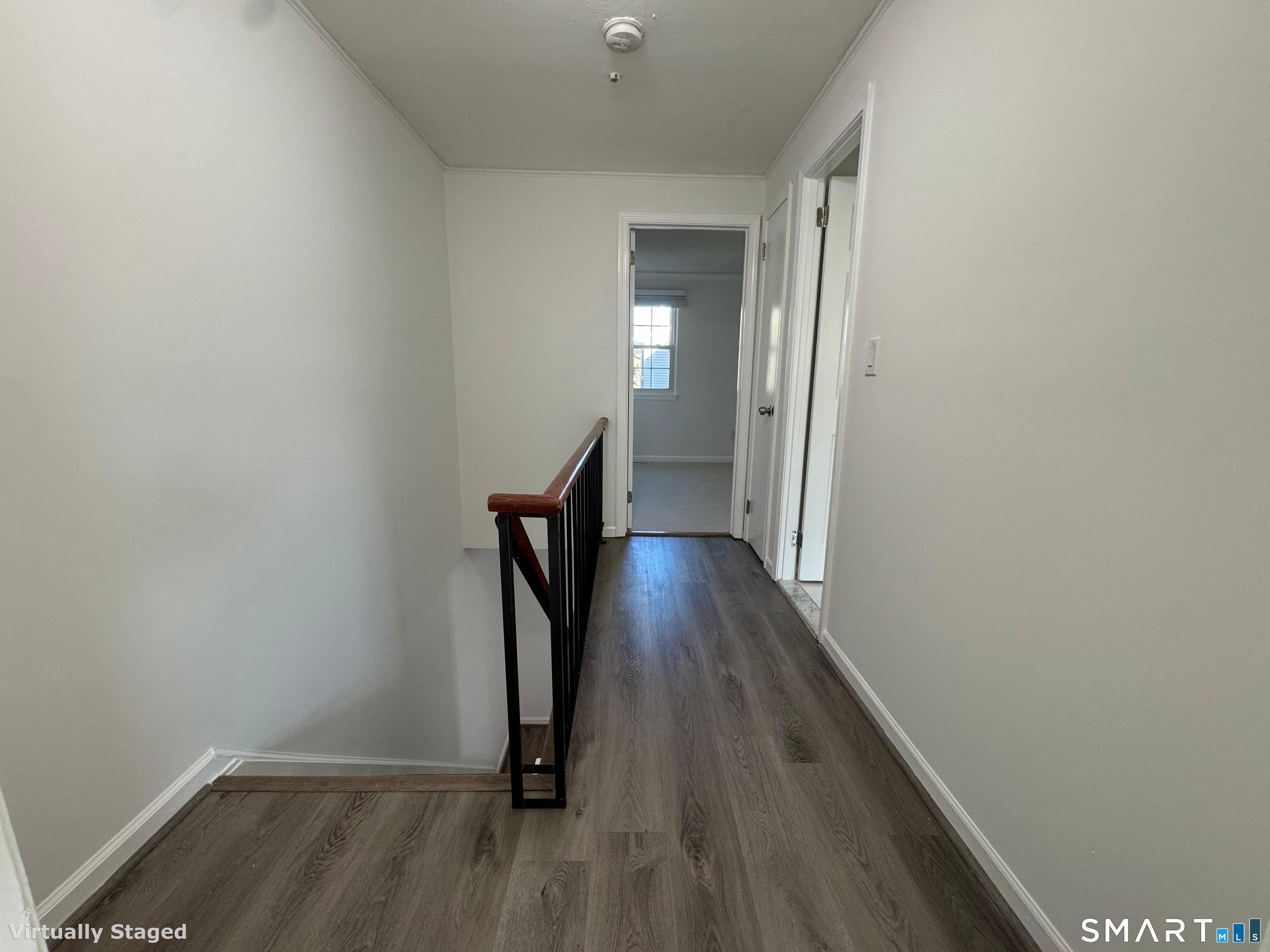 88 East Gate Lane, Unit 88 Hamden, CT 06514 - Photo 23 of 62 a view of a hallway with wooden floor and staircase