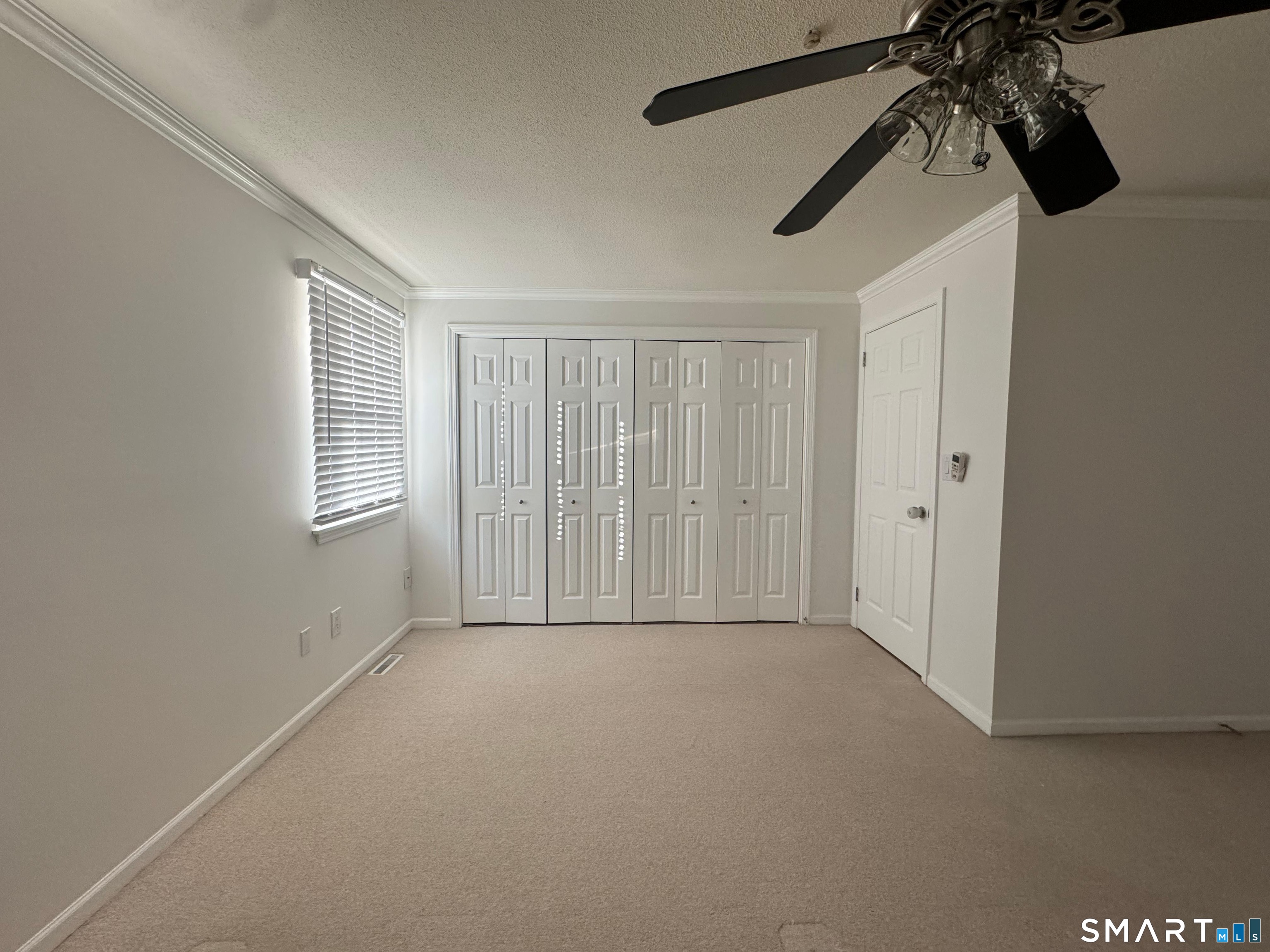 88 East Gate Lane, Unit 88 Hamden, CT 06514 - Photo 25 of 62 a view of a room with a ceiling fan and window