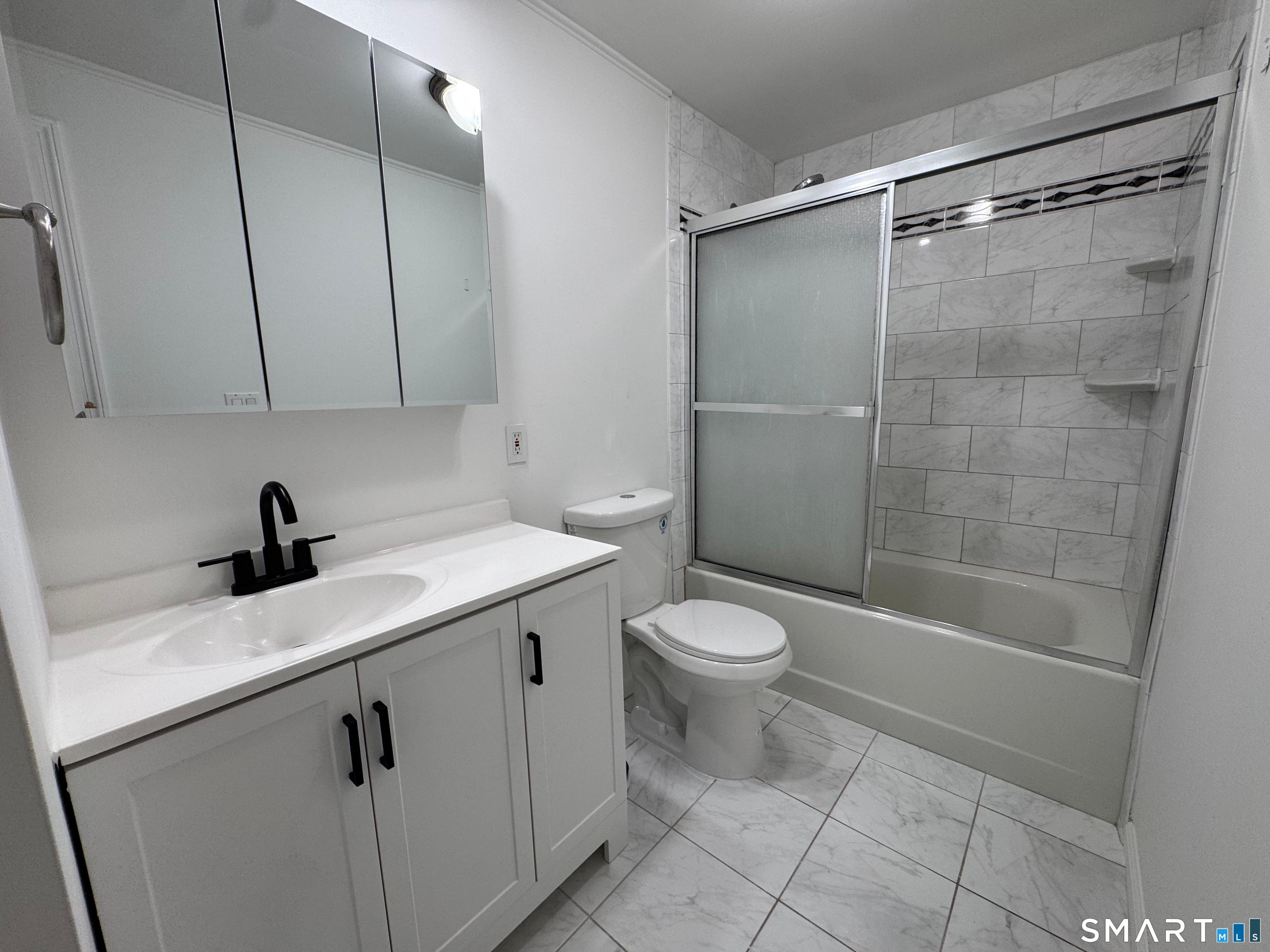 88 East Gate Lane, Unit 88 Hamden, CT 06514 - Photo 26 of 62 a view of a bathroom with a sink a toilet and shower