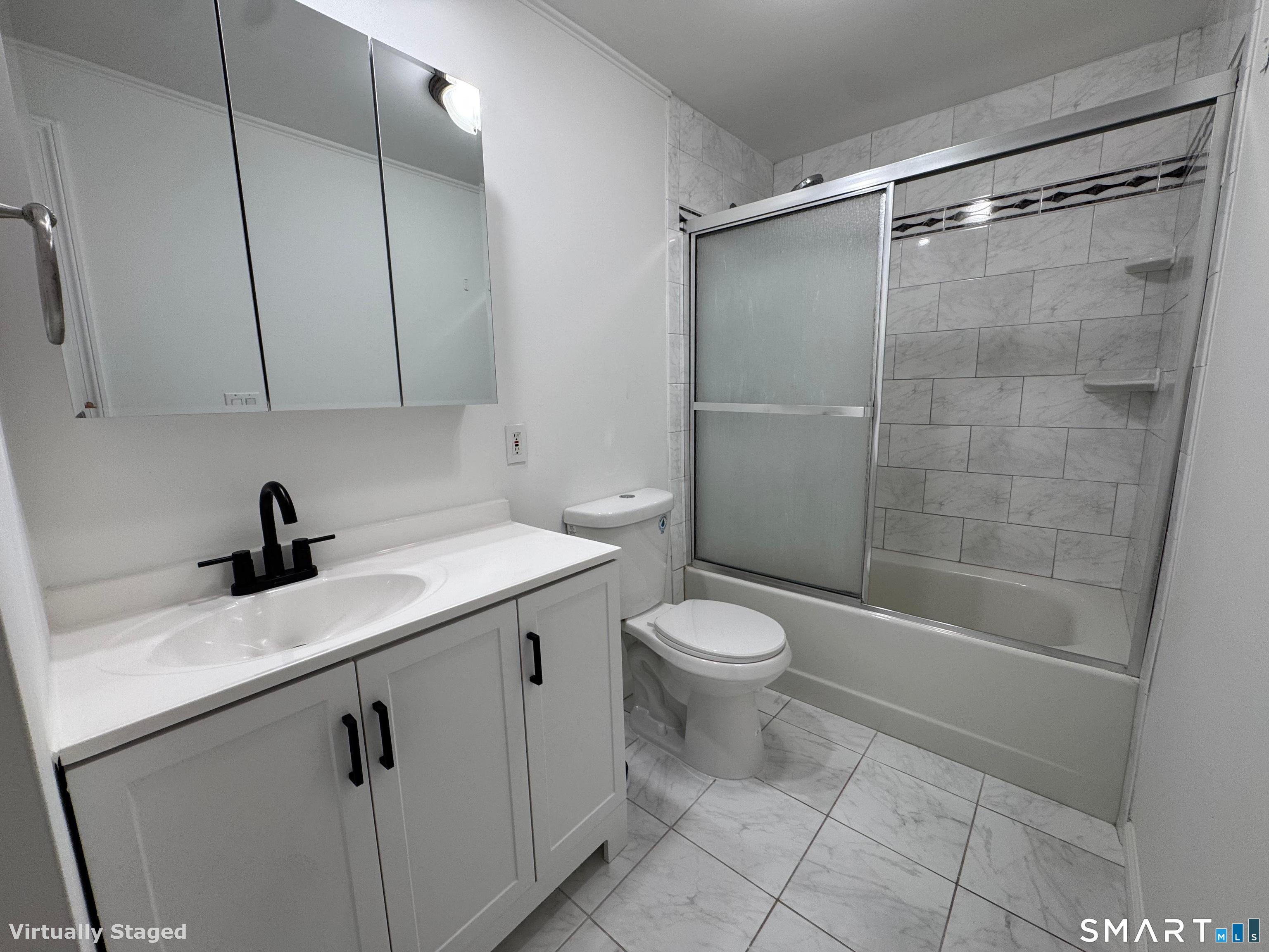 88 East Gate Lane, Unit 88 Hamden, CT 06514 - Photo 27 of 62 a view of a bathroom with a sink a toilet and shower