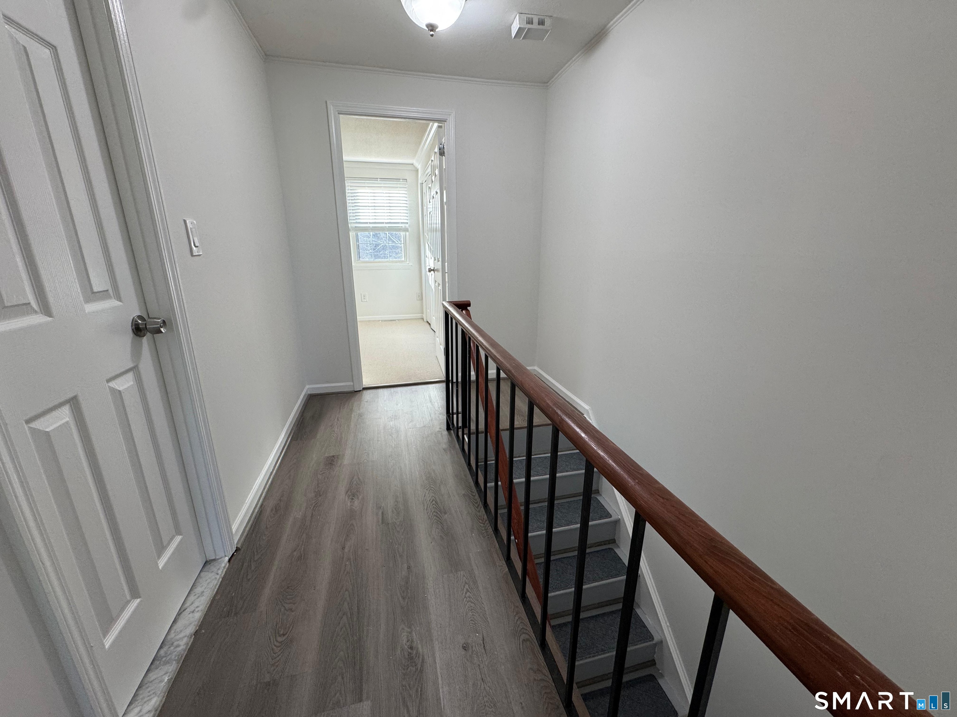 88 East Gate Lane, Unit 88 Hamden, CT 06514 - Photo 36 of 62 a view of a hallway with wooden floor and staircase