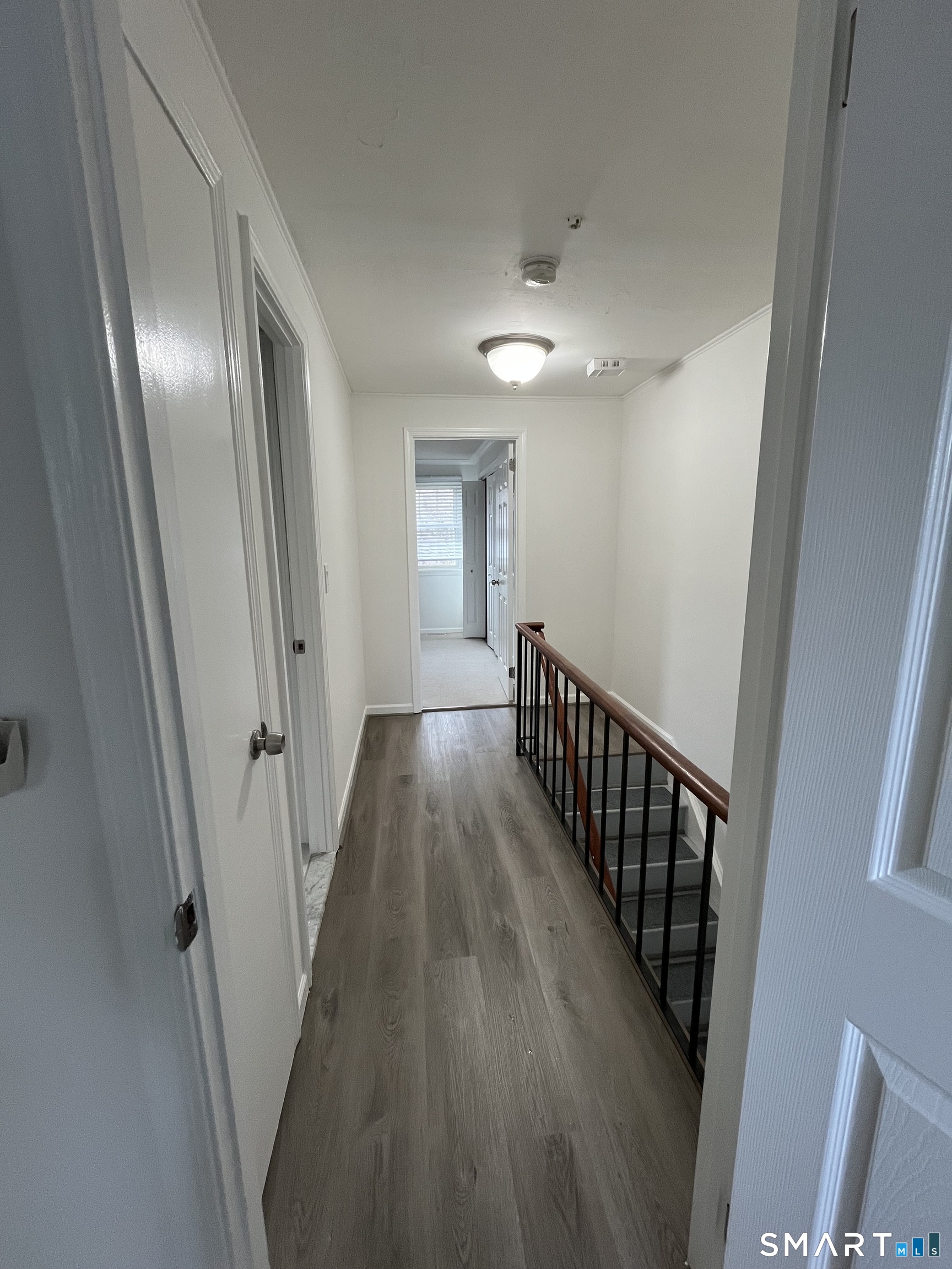 88 East Gate Lane, Unit 88 Hamden, CT 06514 - Photo 38 of 62 a view of a hallway with wooden floor