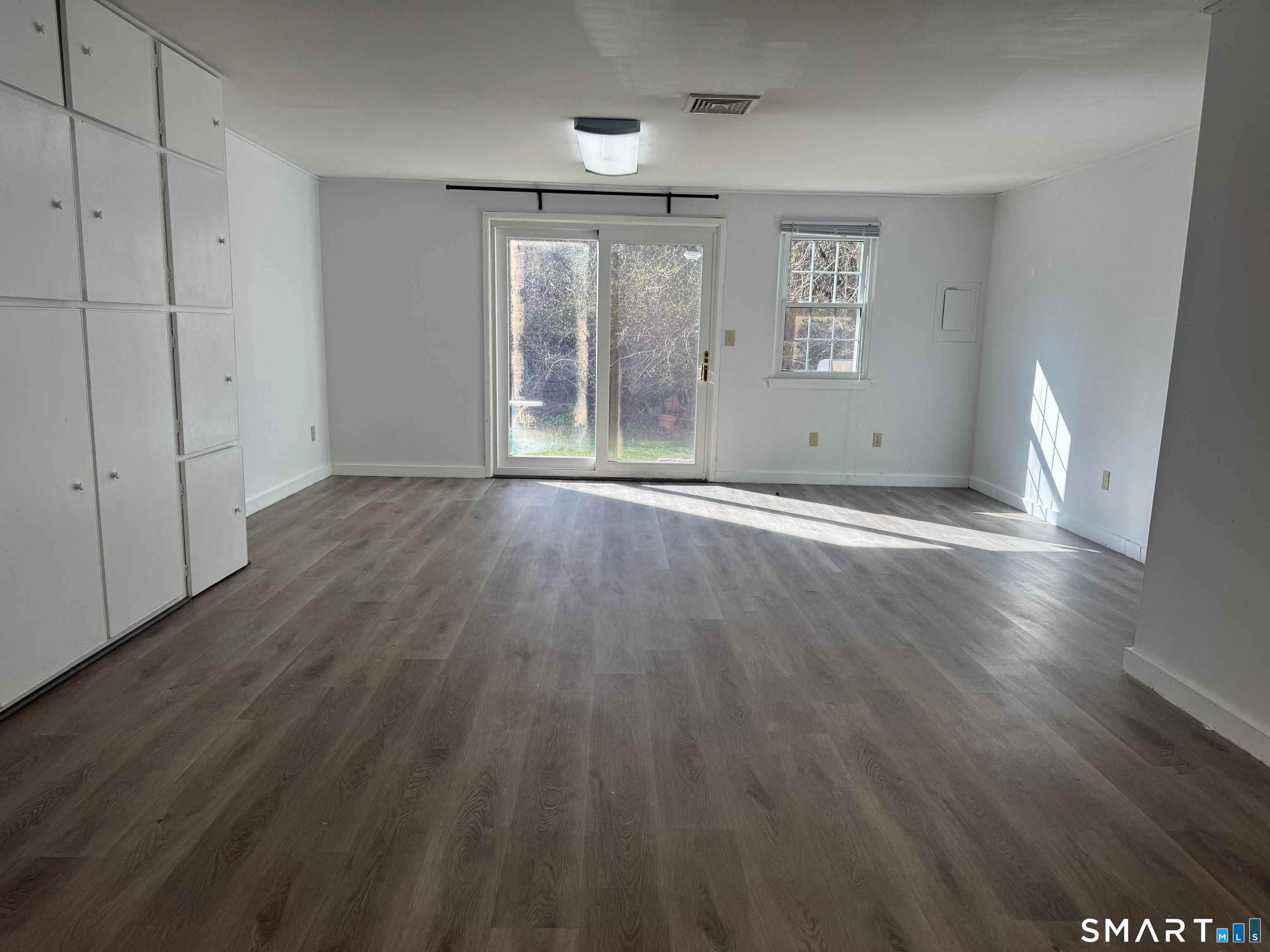 88 East Gate Lane, Unit 88 Hamden, CT 06514 - Photo 43 of 62 an empty room with wooden floor and windows