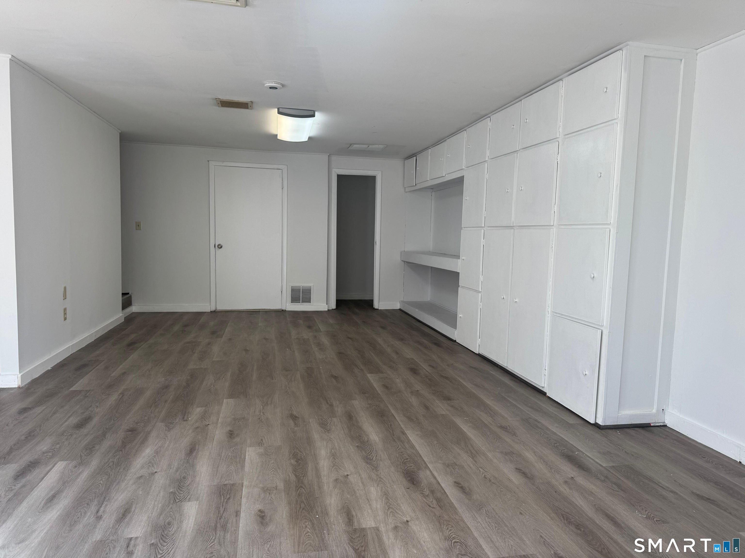 88 East Gate Lane, Unit 88 Hamden, CT 06514 - Photo 45 of 62 a view of a room with wooden floors and white walls