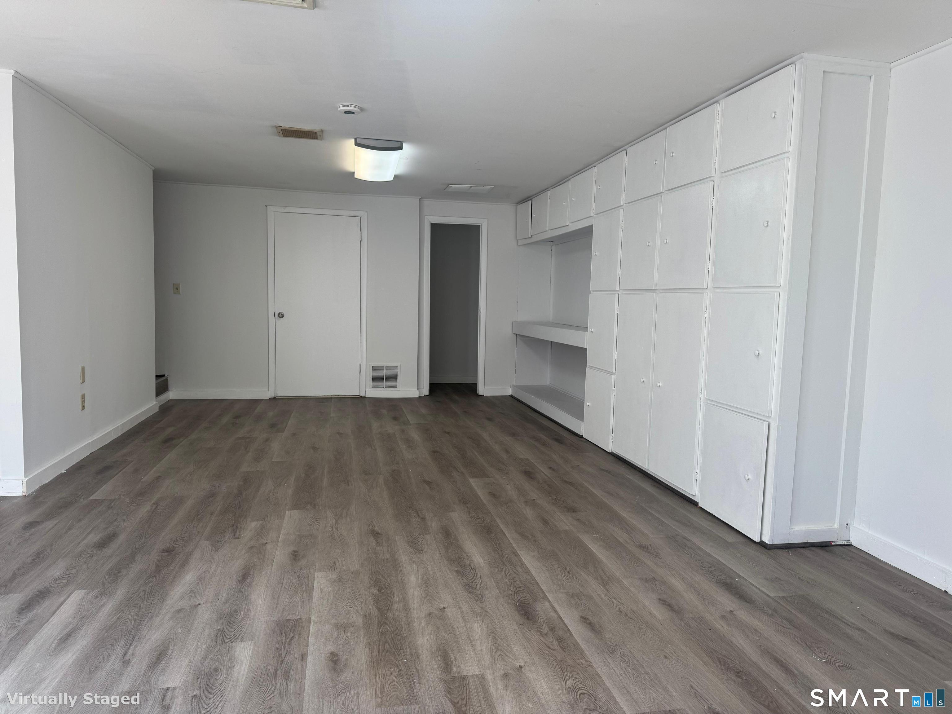 88 East Gate Lane, Unit 88 Hamden, CT 06514 - Photo 48 of 62 a view of a room with wooden floors and white walls