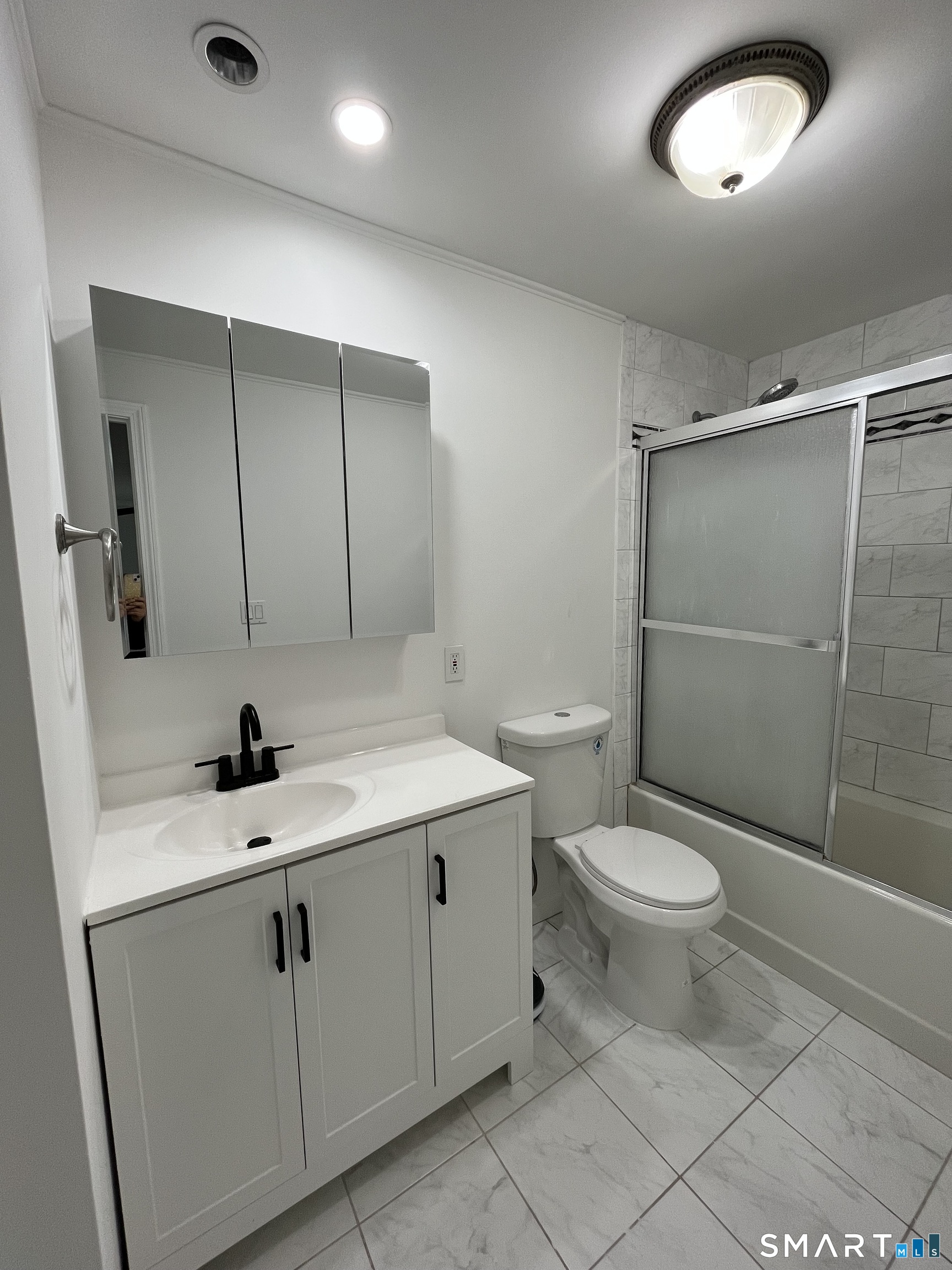 88 East Gate Lane, Unit 88 Hamden, CT 06514 - Photo 10 of 62 a bathroom with a toilet a sink and mirror