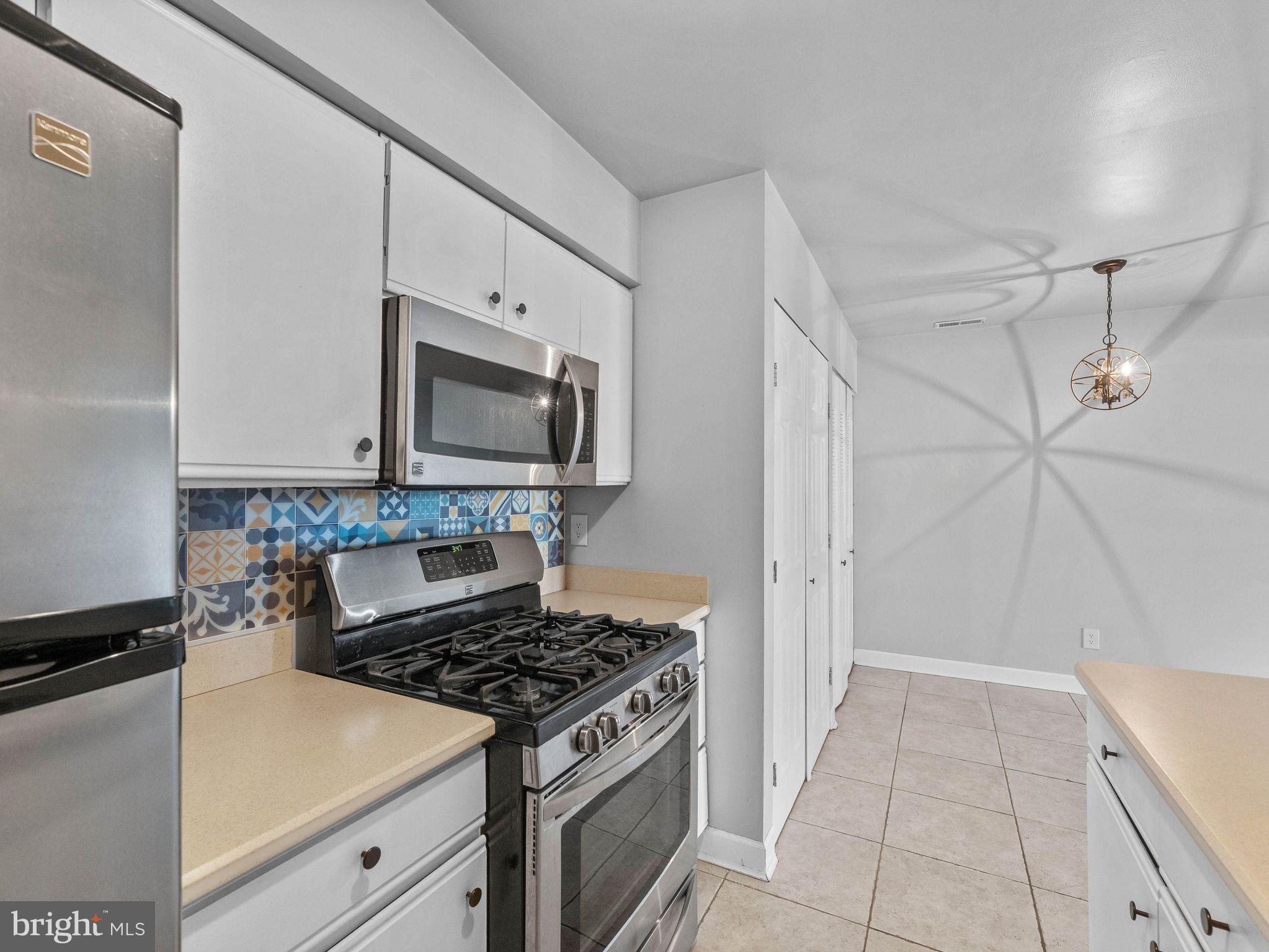 439 Glassboro Road Woodbury Heights, NJ 08097 - Photo 12 of 22 a kitchen with a stove and a microwave