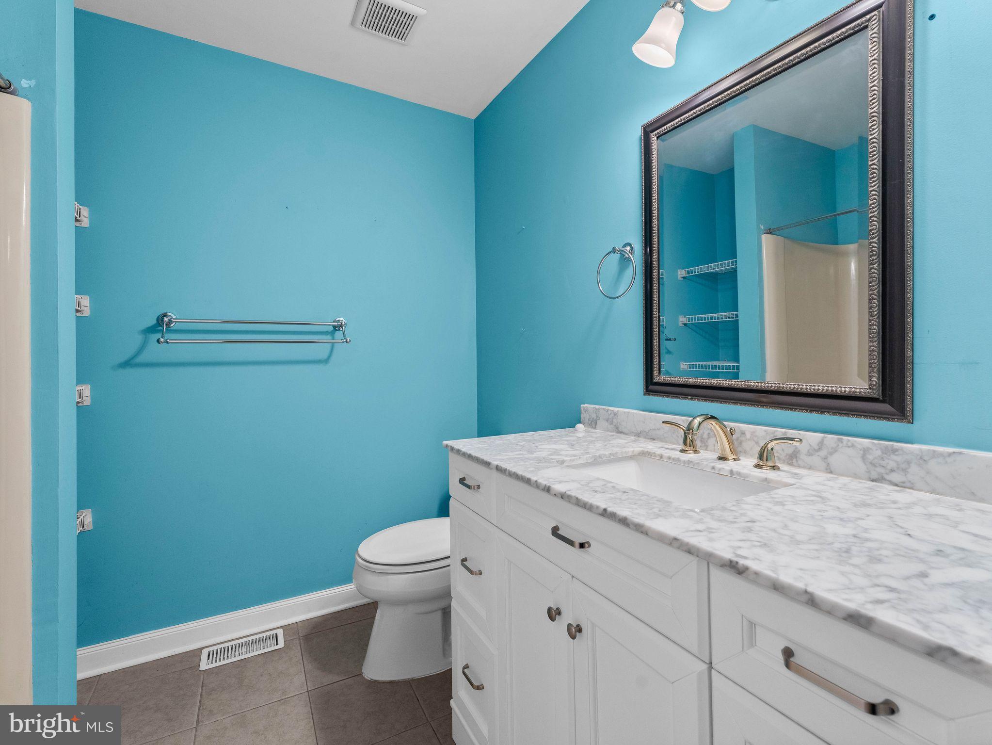 439 Glassboro Road Woodbury Heights, NJ 08097 - Photo 16 of 22 a bathroom with a granite countertop toilet sink and mirror