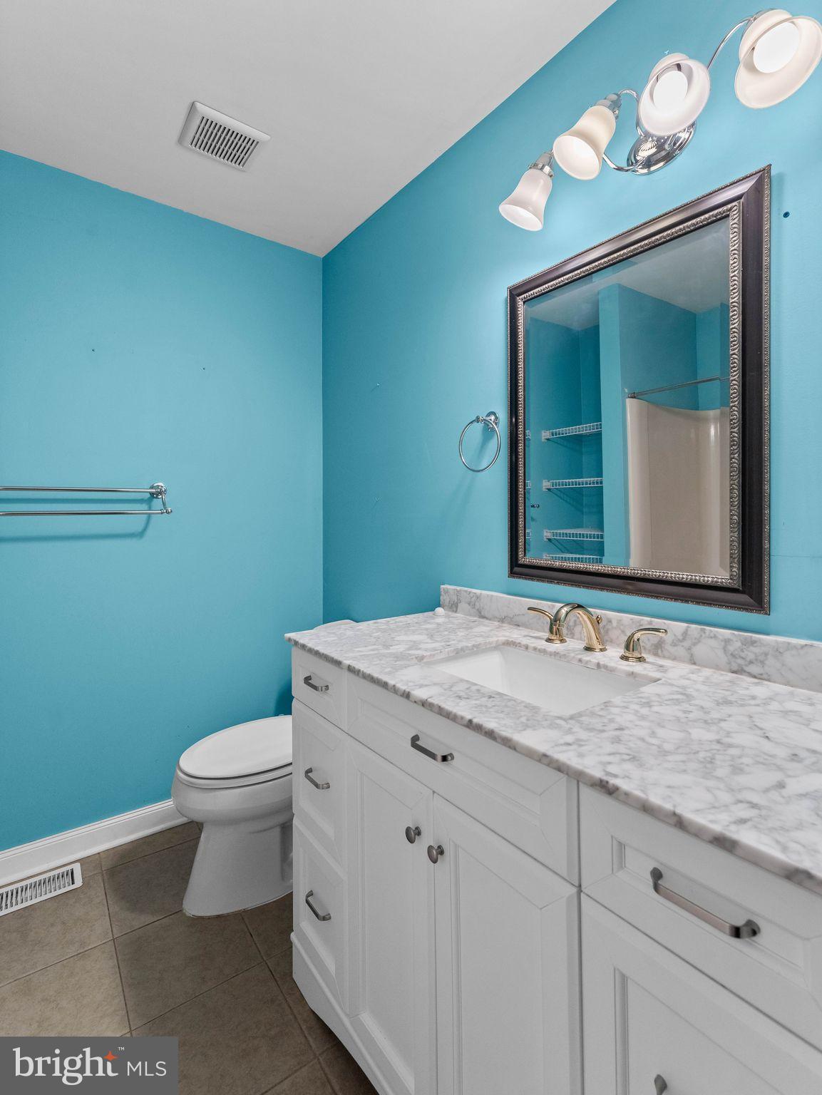 439 Glassboro Road Woodbury Heights, NJ 08097 - Photo 17 of 22 a bathroom with a granite countertop toilet sink mirror and vanity
