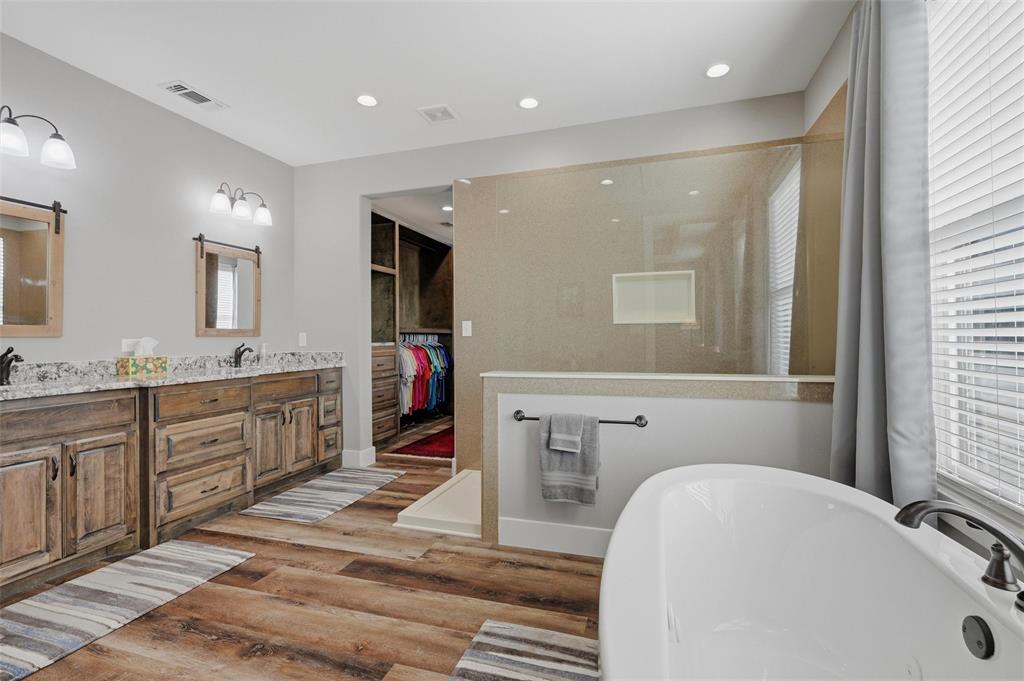 1000 Swindle Road Howe, TX 75459 - Photo 21 of 40 a spacious bathroom with a tub sink and mirror