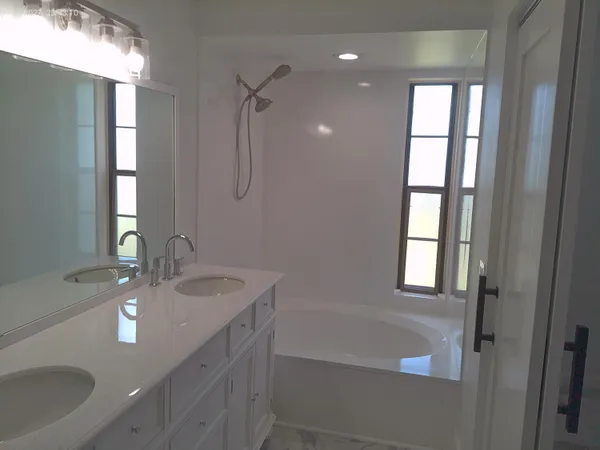 a bathroom with a sink a tub and a mirror
