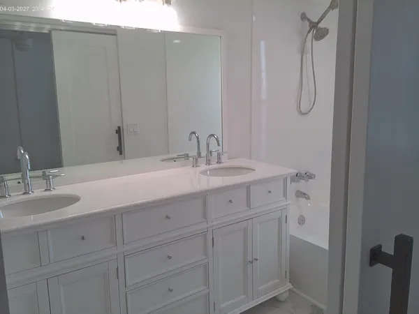 a bathroom with a double vanity sink and mirror