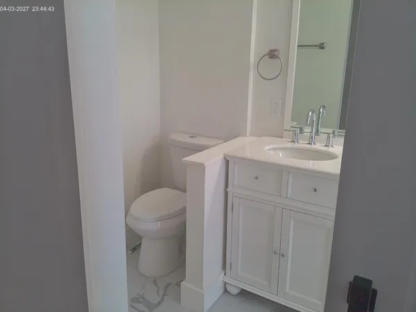 a bathroom with a sink a toilet and a mirror