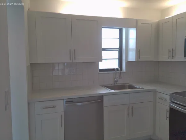a kitchen with a sink cabinets and window