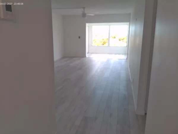 a view of an empty room and a window
