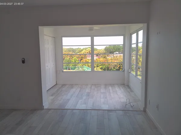 an empty room with large window