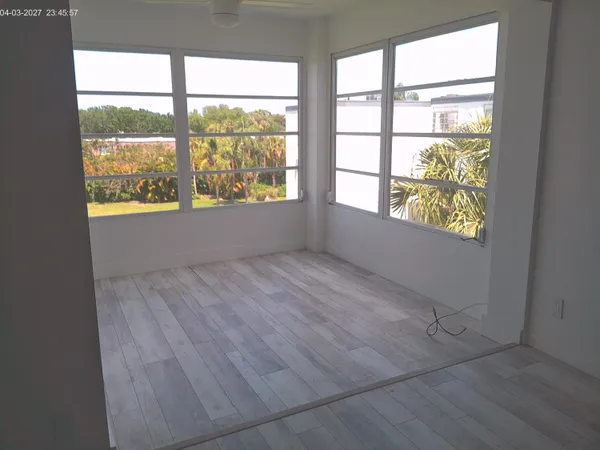 an empty room with large windows