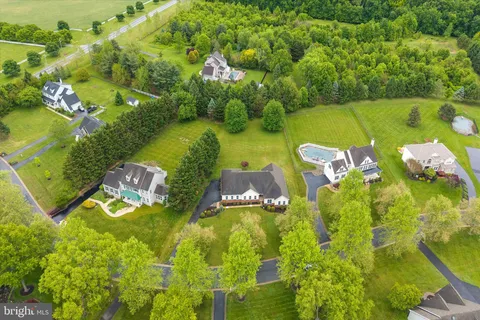 an aerial view of a residential houses with swimming pool and outdoor space