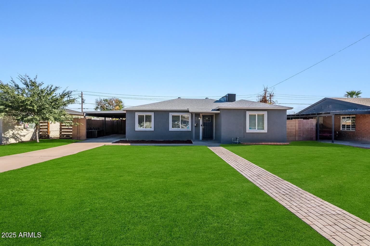 a front view of a house with a garden