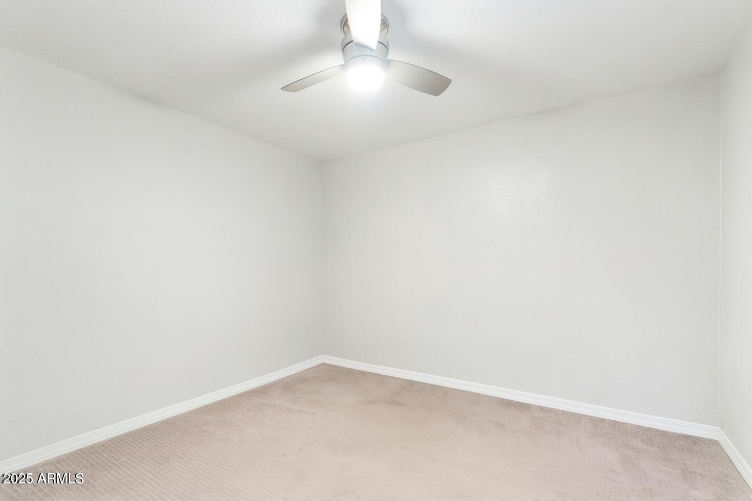 2147 West Osborn Road Phoenix, AZ 85015 - Photo 11 of 29 an empty room with a empty space and a ceiling fan