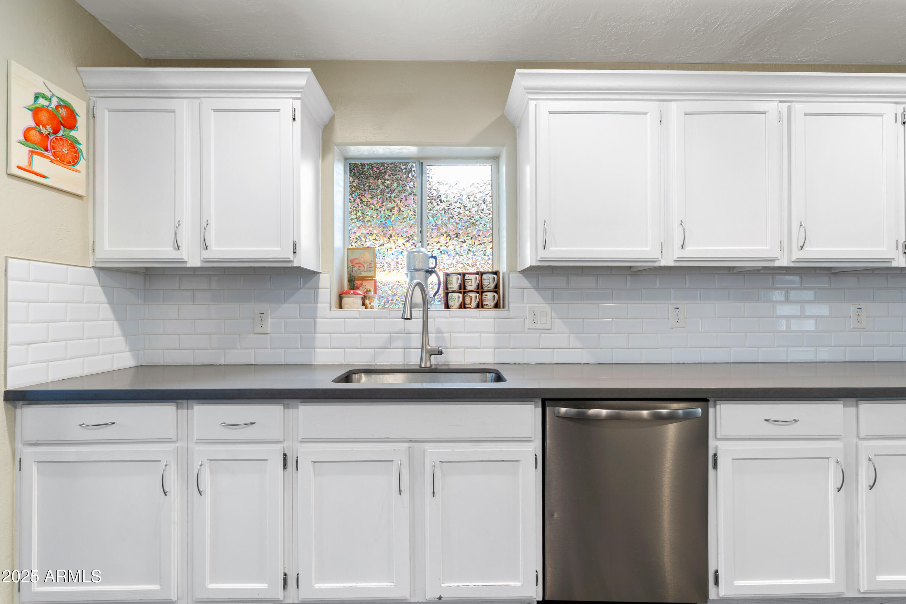 2147 West Osborn Road Phoenix, AZ 85015 - Photo 8 of 29 a kitchen with granite countertop white cabinets and a sink