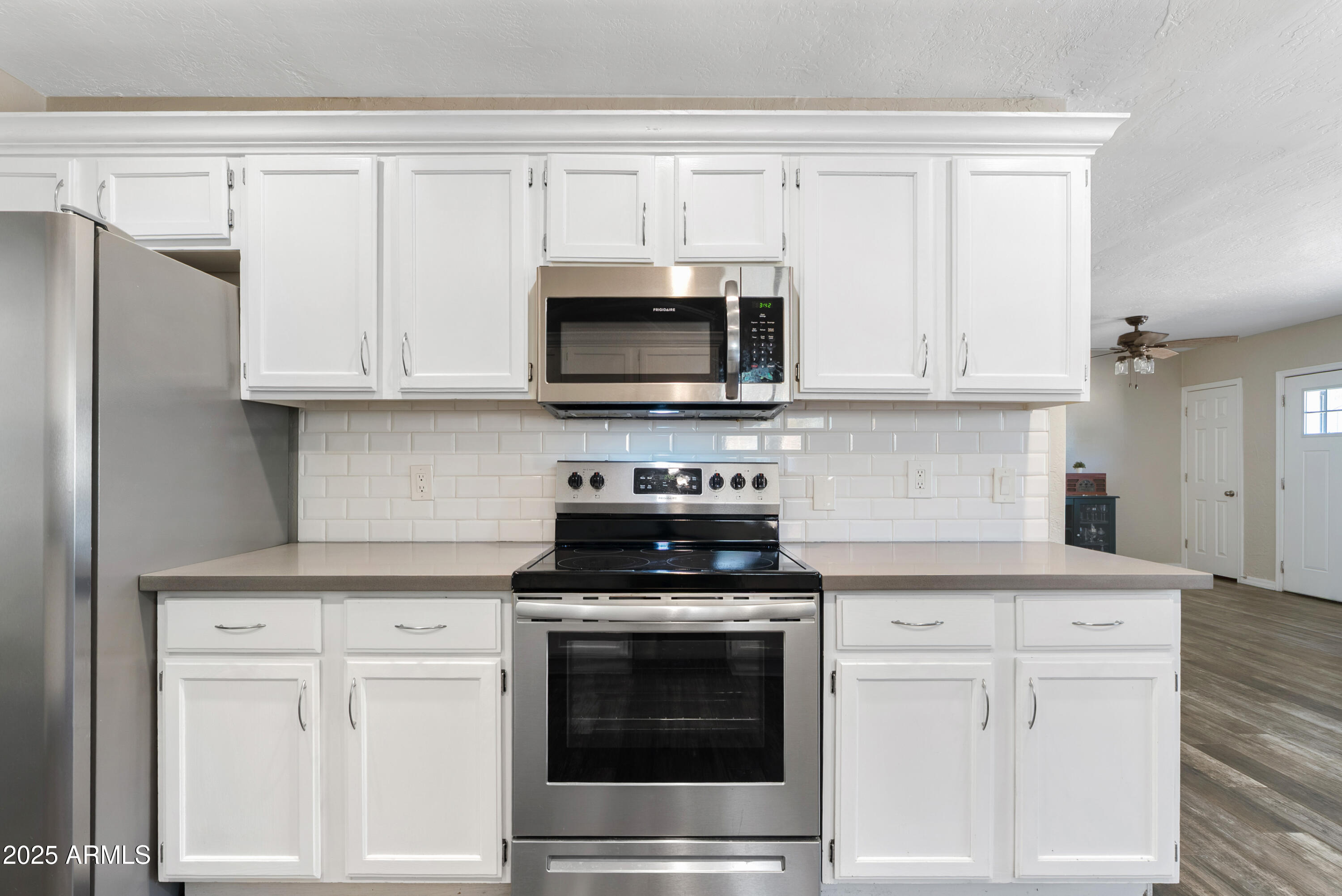 2147 West Osborn Road Phoenix, AZ 85015 - Photo 9 of 29 a kitchen with white cabinets and stainless steel appliances