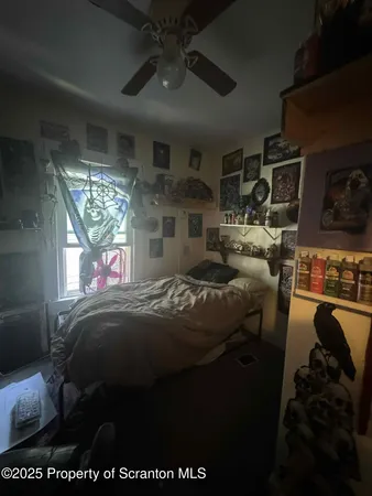 a bed sitting in a bedroom next to a window