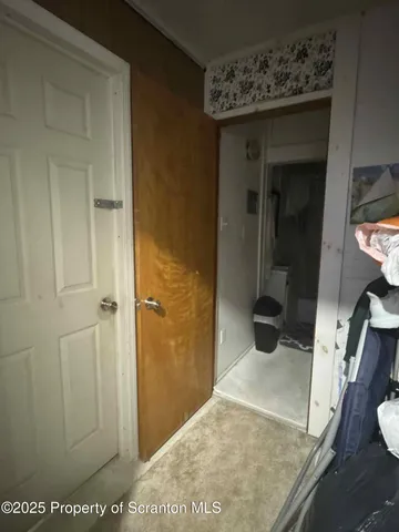 a view of a bedroom from a hallway