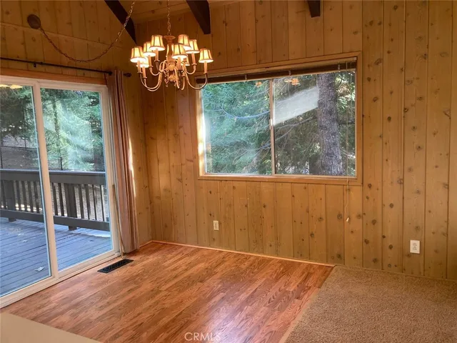 a balcony with wooden floor and fence