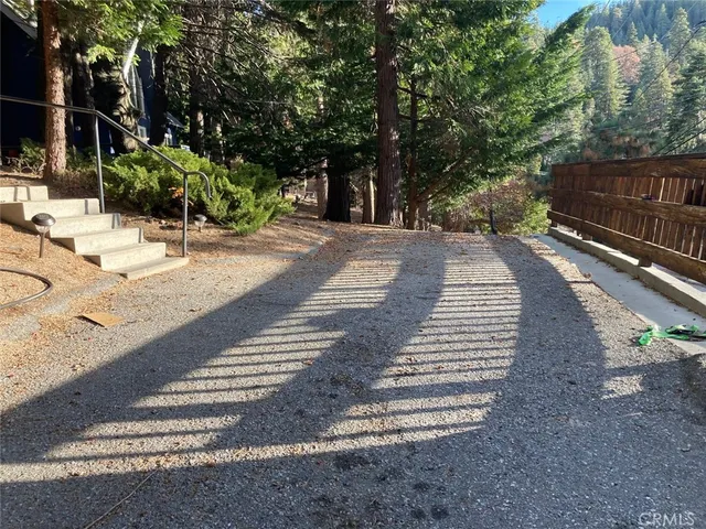 a view of staircase with lots of frames on wall and a large window