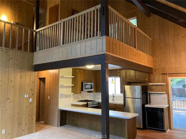 a kitchen with stainless steel appliances a refrigerator and a stove