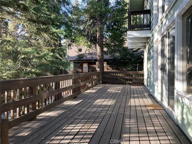a view of a balcony with wooden floor