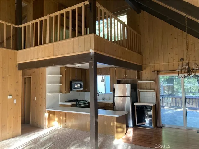 a view of staircase with kitchen view