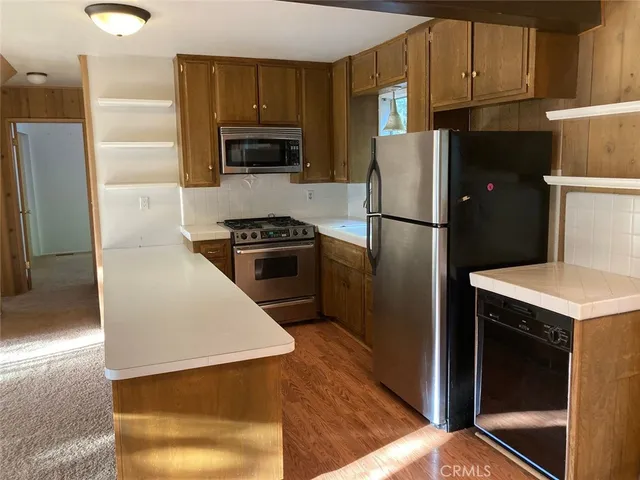 a view of a room with wooden floor and large windows