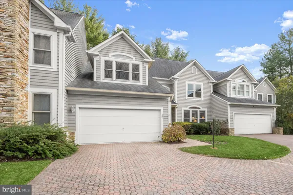 a front view of a house with a garden and plants