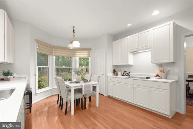 a kitchen with stainless steel appliances kitchen island granite countertop a stove refrigerator and cabinets