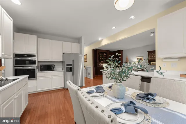 a living room with furniture a flat screen tv and a table