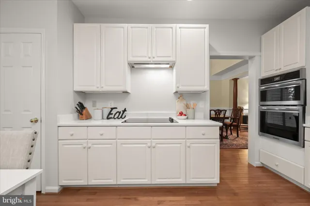 a kitchen with stainless steel appliances kitchen island granite countertop a refrigerator and cabinets