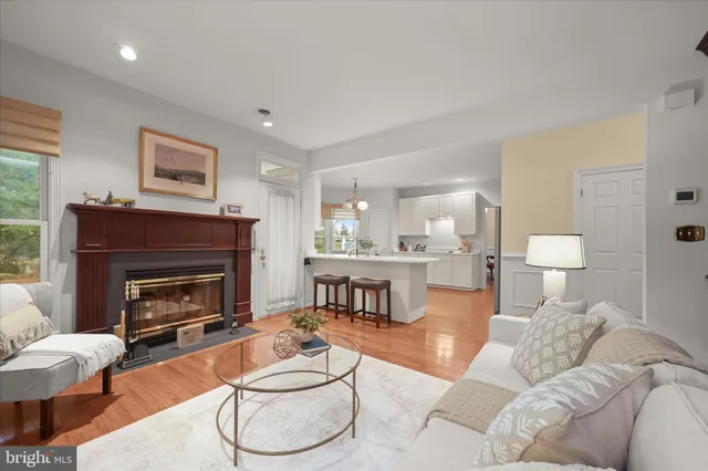 a living room with furniture a rug and kitchen view