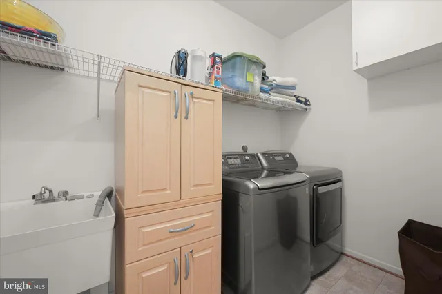 a spacious bedroom with a bed and wooden floor