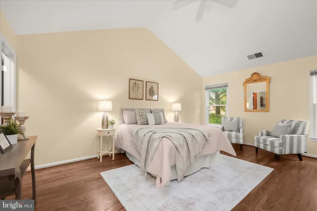 a bedroom with a large bed and a flat tv screen