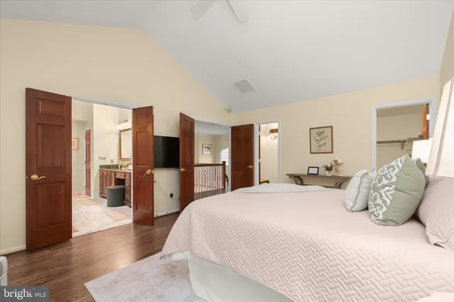 a bathroom with a granite countertop tub sink and mirror