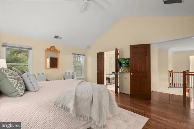a spacious bathroom with a tub sink shower and mirror