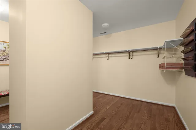 a view of a bedroom with furniture wooden floor and window