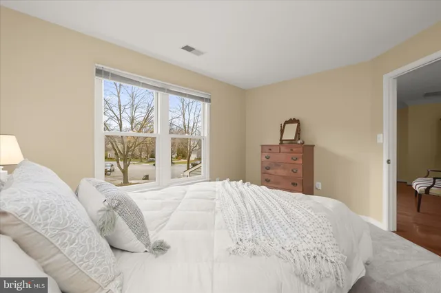 a spacious bedroom with a bed and a couch