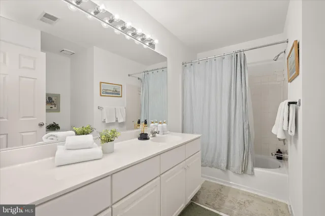 a living room with furniture and a wall painting