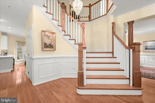 a view of entryway and hall with wooden floor