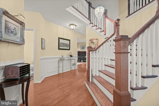 a view of entryway and hall with wooden floor
