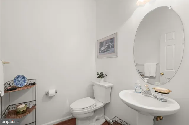 a bathroom with a sink toilet and a mirror